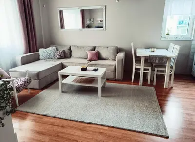 a living room with a couch and a table at Apartman Đul in Mladenovac