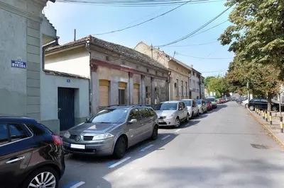 a row of cars parked on the side of a street at Biser 17 in Zemun