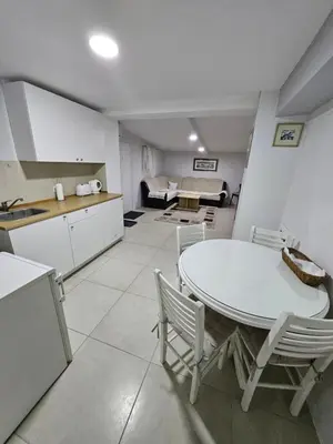 a kitchen and dining room with a table and chairs at Atina in Žarkovo