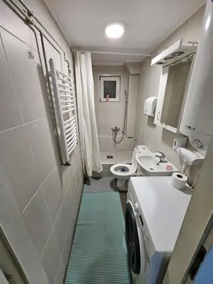 a bathroom with a sink and a washing machine at Atina in Žarkovo