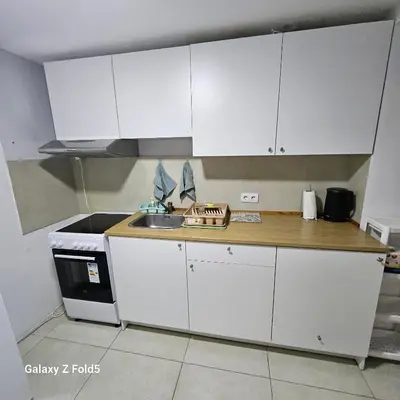 a kitchen with white cabinets and a sink at Atina in Žarkovo