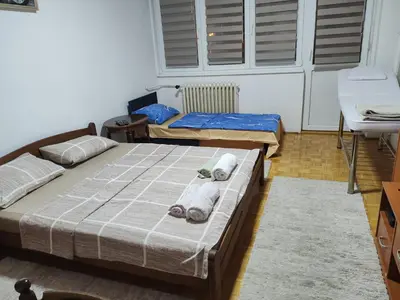 a bedroom with two beds with towels on it at Relax apartman bg in Belgrade