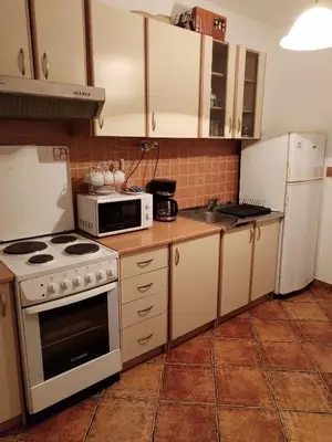 a kitchen with a white stove and a microwave at Relax apartman bg in Belgrade