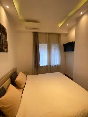 a bedroom with a bed and a window at Grand Residency Luksuzan stan u centru grada in Belgrade