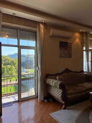 a living room with a couch and a sliding glass door at Grand Residency Luksuzan stan u centru grada in Belgrade
