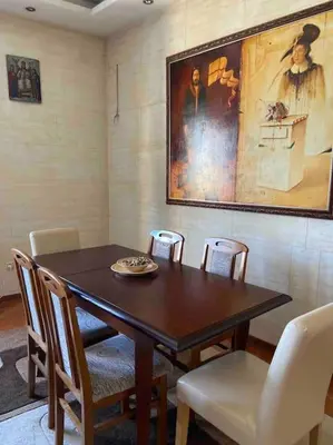 a dining room table with chairs and a painting on the wall at Grand Residency Luksuzan stan u centru grada in Belgrade