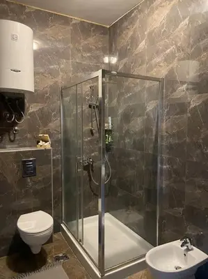 a bathroom with a shower and a toilet and a sink at Grand Residency Luksuzan stan u centru grada in Belgrade