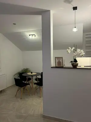 a dining room with a table and chairs at Apartman Cristal LUX in Surčin