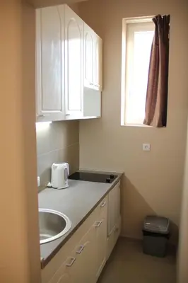 a small kitchen with a sink and a window at Downtown Skadarlija in Belgrade