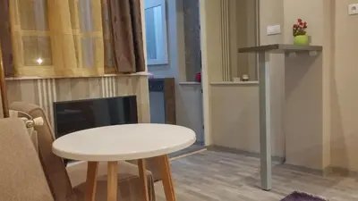 a small white table and stool in a room at Downtown Skadarlija in Belgrade