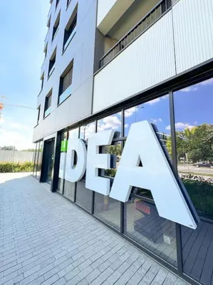 a building with a sign on the side of it at West 65 airport city apartment in Belgrade