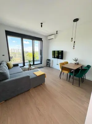 a living room with a couch and a table at West 65 airport city apartment in Belgrade