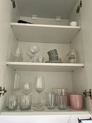 a bunch of glasses sitting on shelves in a kitchen at Maxim in Pančevo