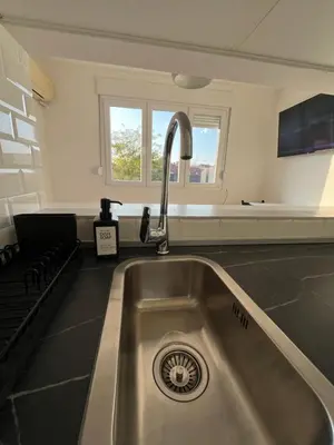 a kitchen sink with a faucet in a kitchen at Maxim in Pančevo