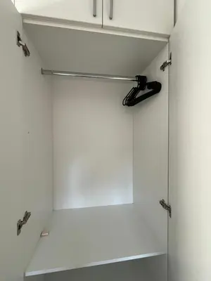 a bathroom with a white closet with aabinet at Maxim in Pančevo