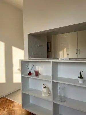 a white shelf in a room with white cabinets at Maxim in Pančevo