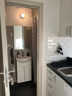 a small kitchen with a sink and a mirror at Maxim in Pančevo