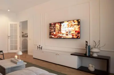a living room with a tv hanging on the wall at Designer flat with character in Belgrade