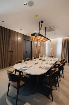 a conference room with a large white table and chairs at Hotel Flaneur in Belgrade