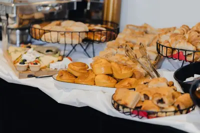 a table filled with different types of pastries and desserts at Hotel Flaneur in Belgrade