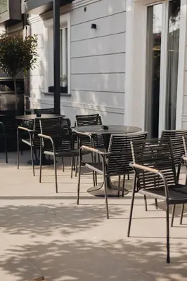 a group of tables and chairs in front of a building at Hotel Flaneur in Belgrade
