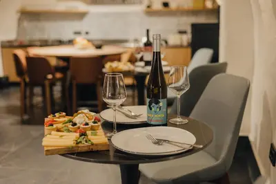 a table with a bottle of wine and two glasses at Hotel Flaneur in Belgrade