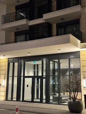 a building with large glass doors in front at Waterfront Retreat with Garage and Balcony in Belgrade