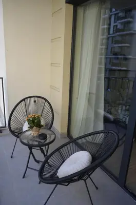 two chairs and a table on a balcony at Waterfront Retreat with Garage and Balcony in Belgrade