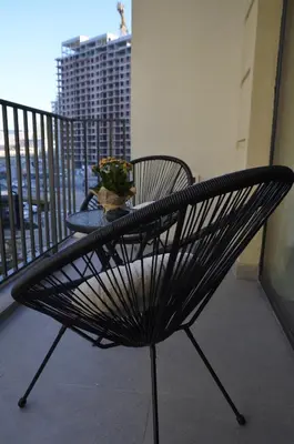a black bench on a balcony with a table at Waterfront Retreat with Garage and Balcony in Belgrade