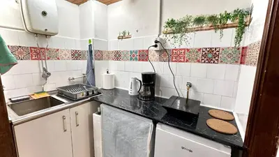 a kitchen with a sink and a counter top at Sunset apartment in Belgrade