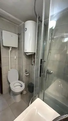 a small bathroom with a toilet and a shower at Sunset apartment in Belgrade