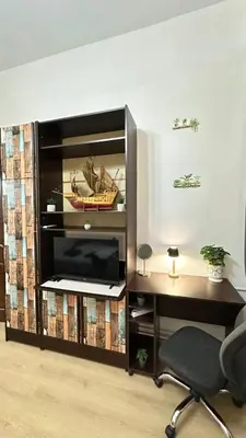 a desk and a chair in a room with a tv at Sunset apartment in Belgrade