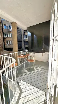 a balcony with a table and chairs on a building at Sunset apartment in Belgrade