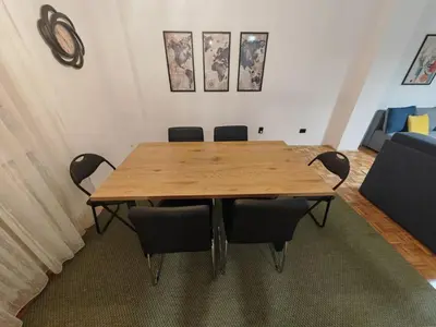 a conference room with a wooden table and chairs at NEW BELGRADE Lovely three bedroom apartment in Belgrade