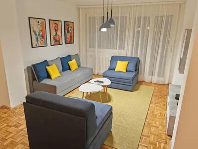 a living room with two couches and yellow pillows at NEW BELGRADE Lovely three bedroom apartment in Belgrade