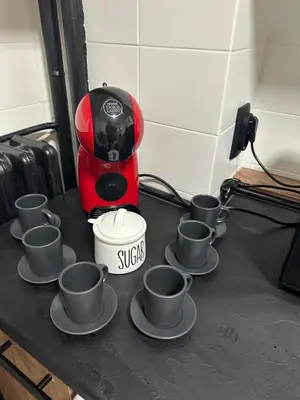 a red coffee maker with sixteen cups on a counter at NEW BELGRADE Lovely three bedroom apartment in Belgrade