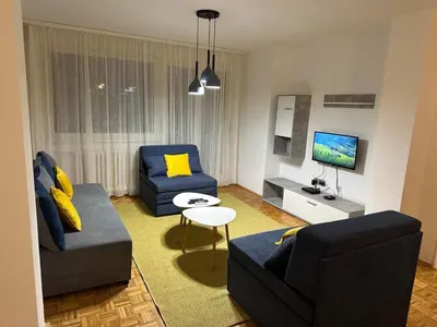a living room with two couches and a tv at NEW BELGRADE Lovely three bedroom apartment in Belgrade