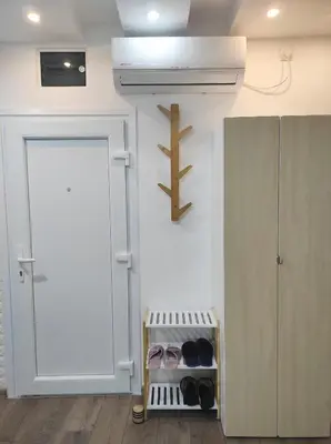 a room with a door and a shelf with shoes at Wood Studio in Belgrade