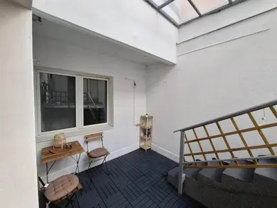 a room with a staircase and a table and a window at Wood Studio in Belgrade