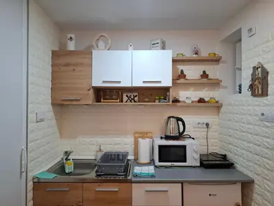 a kitchen with a counter top with a microwave at Wood Studio in Belgrade