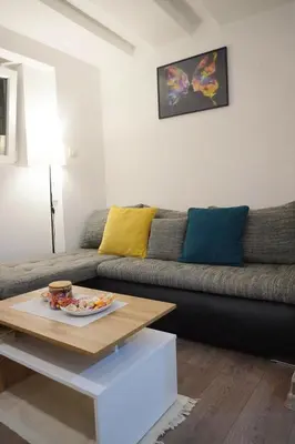 a living room with a couch and a table at Wood Studio in Belgrade