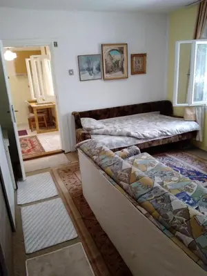 a room with two beds in a room with a doorway at Home in flowers in Belgrade