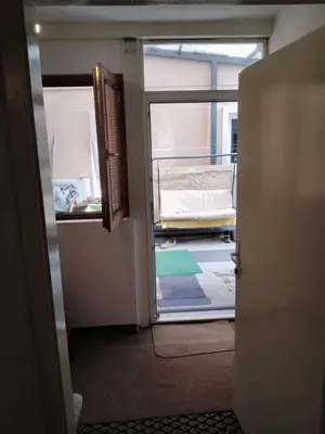 an open door to a room with a bed in it at Home in flowers in Belgrade