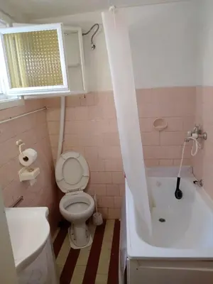 a bathroom with a toilet and a tub and a sink at Home in flowers in Belgrade