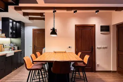a kitchen with a wooden table and chairs at Serenity hill in Draževac