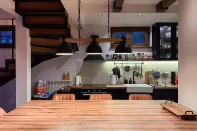 a kitchen with a large wooden table with chairs at Serenity hill in Draževac