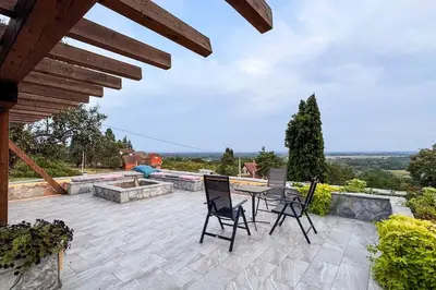 a patio with chairs and a table and a fountain at Serenity hill in Draževac