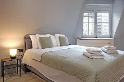 a bedroom with a bed with towels on it at Apartman Paradise Slavija Dos in Belgrade