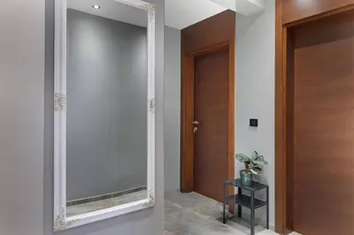 a mirror in a hallway next to a door at Apartman Paradise Slavija Dos in Belgrade