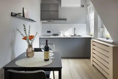 a kitchen with a table with a bottle of wine at Apartman Paradise Slavija Dos in Belgrade